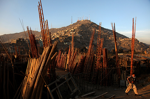 A boy buying firewood from a roadside stall. Kabul, 2011.